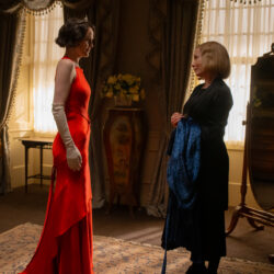 Two characters from Downton Abbey, facing each other in a grand room.