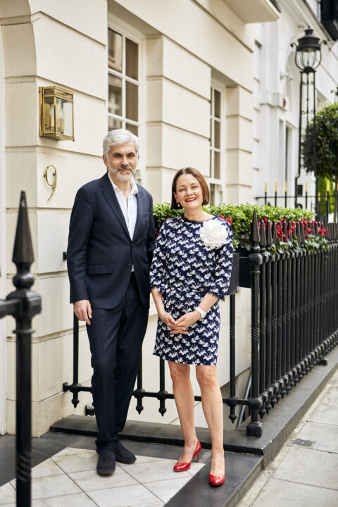 Our managing directors, Aude and Vladimir, standing on the steps outside 9 Hertford Street which is a Georgian townhouse.