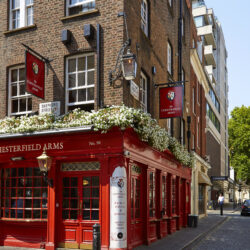 The red painted exterior of historic The Chesterfield Arms pub on the corner of Hertford Street.