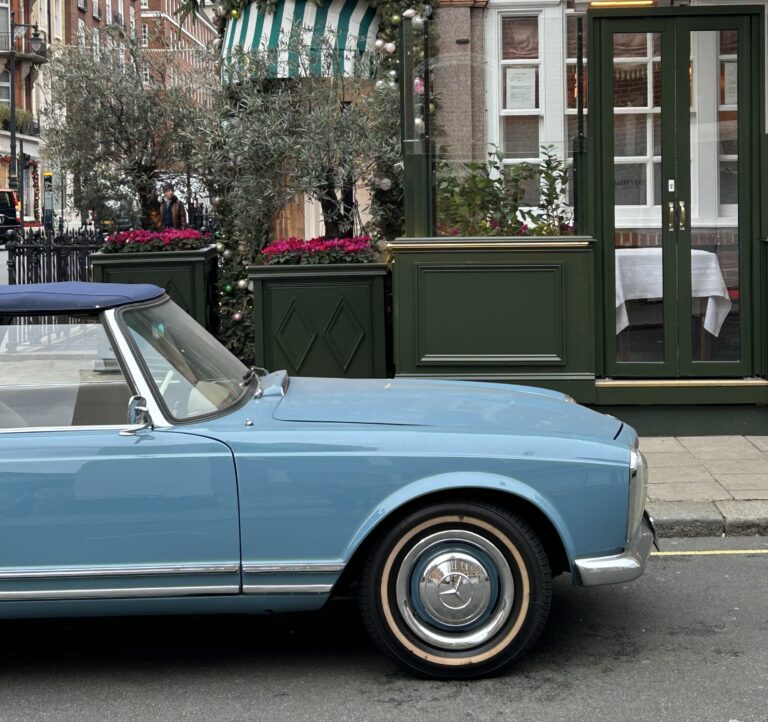 A classic blue car on a street in Mayfair.