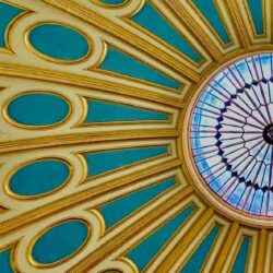 A beautifully decorated domed ceiling, painted in gold and turquoise.