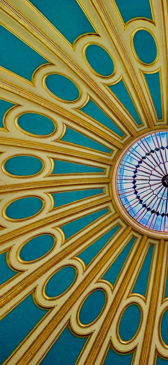 A beautifully decorated domed ceiling, painted in gold and turquoise.