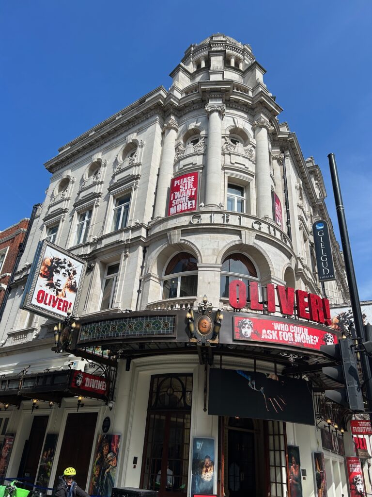 The exterior of the Gielgud Theatre, with advertising for Oliver!