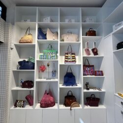 A collection of colourful bags on white shelves at Anya Life.