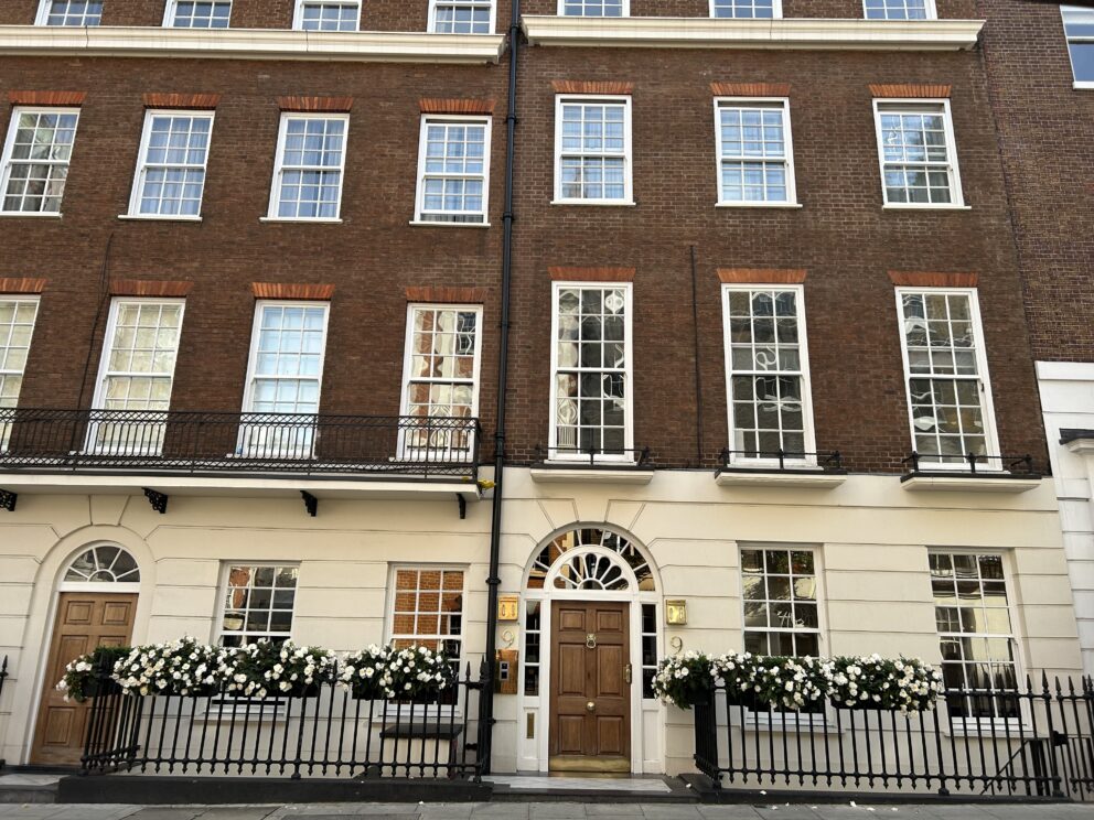 The Georgian facade of 8 & 9 Hertford Street with sash windows and fanlights over doors.