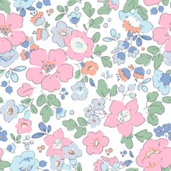 Close up detail of Liberty London fabric, depicting pale pink and pale blue flowers, and pale green leaves on a white background.